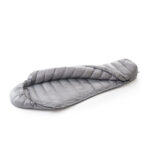 Gray down sleeping bag laid flat on a white background with quilted panels exposed.